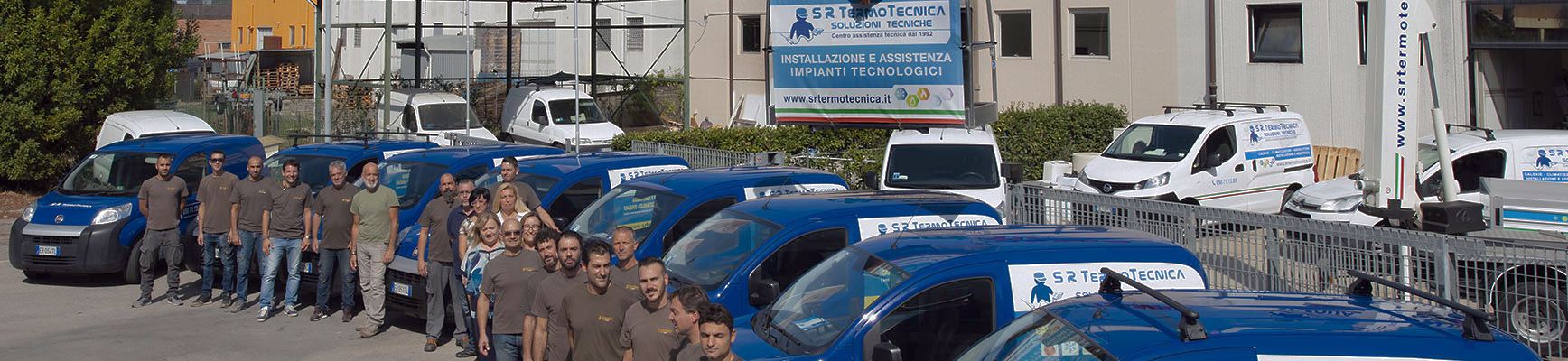 Il personale di S.R. Termotecnica schierato accanto ai furgoni aziendali, davanti alla sede